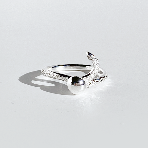 A silver ring with a textured band and a spherical embellishment on the top, displayed against a white background.
