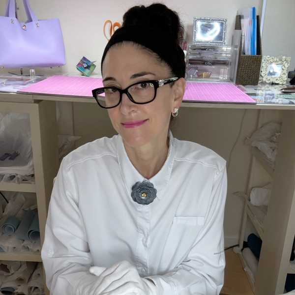California Artist Lisa Ramos from MONOLISA in her Clayton, CA studio wearing one of her Magnetic Leather Flower Designs on a white shirt and her signature Earring Jackets with Simulated Diamonds