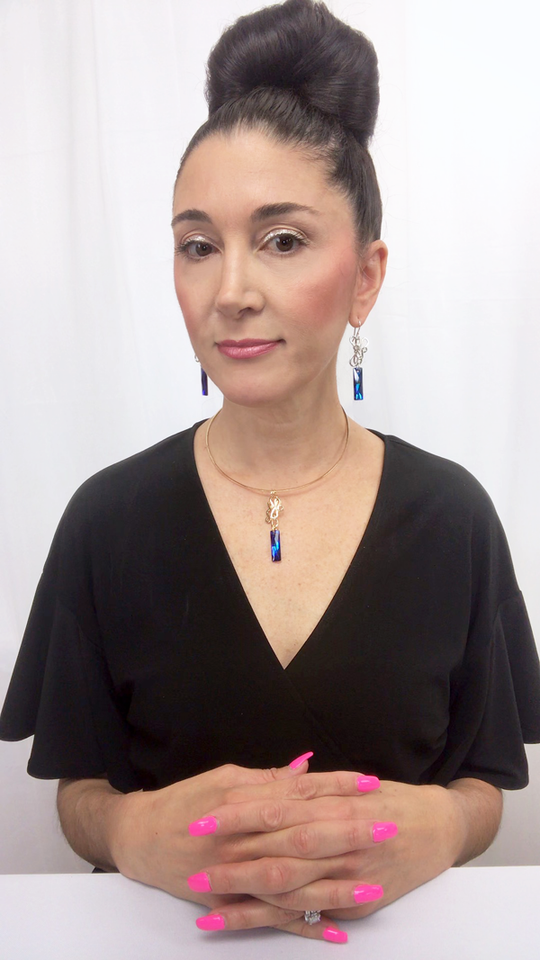 Designer, Lisa Ramos showcasing a the blue pendant.  
